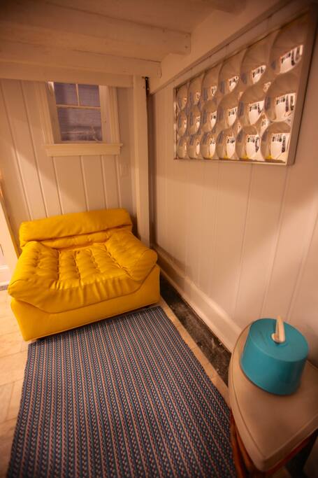 When 2nd bed isn't set up us this comfy 60s chair for lounging.
