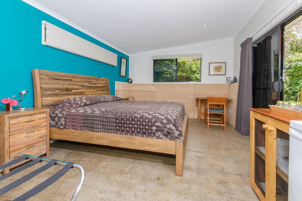 Spacious bedroom tastefully appointed, including a king-size bed
