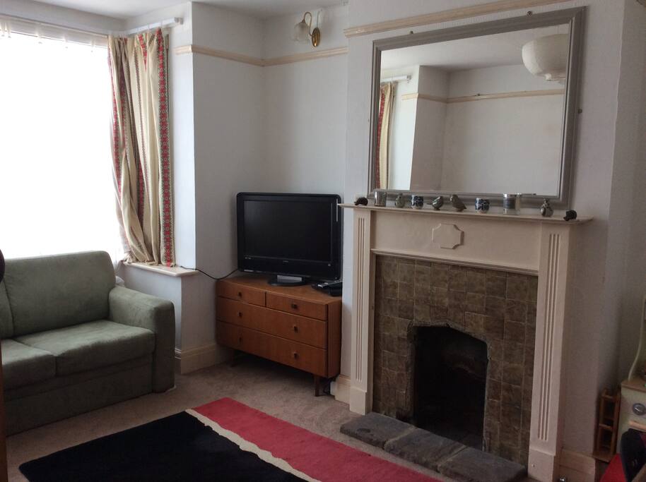 Comfy lounge with two sofas and bay window.