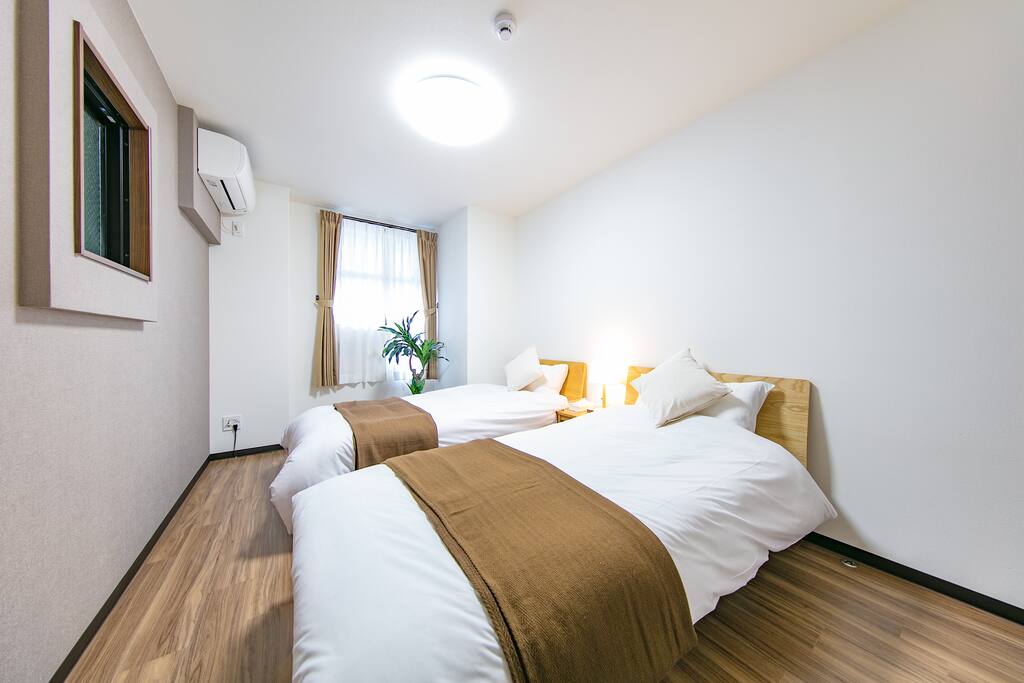 Two rooms, both with two beds, and an AC.