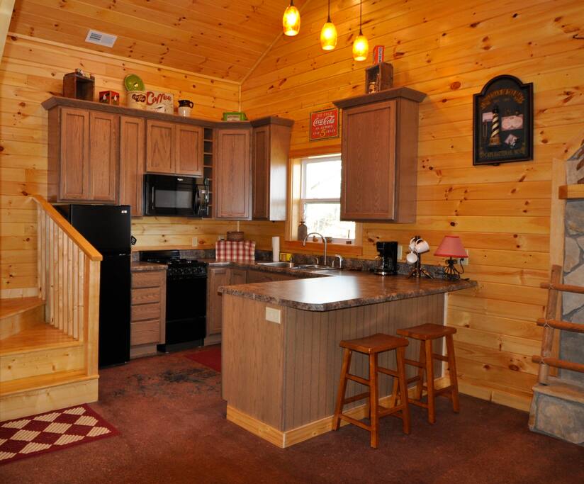 Fully stocked kitchen with gas stove, microwave, dishwasher, coffee maker & condiments.