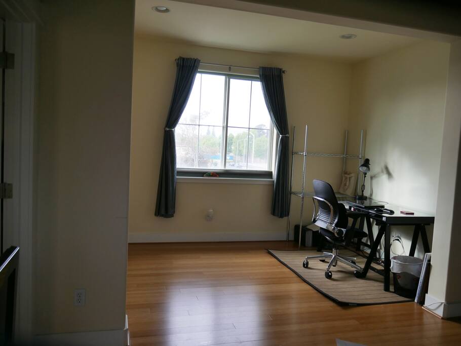 Den area with desk and shelving