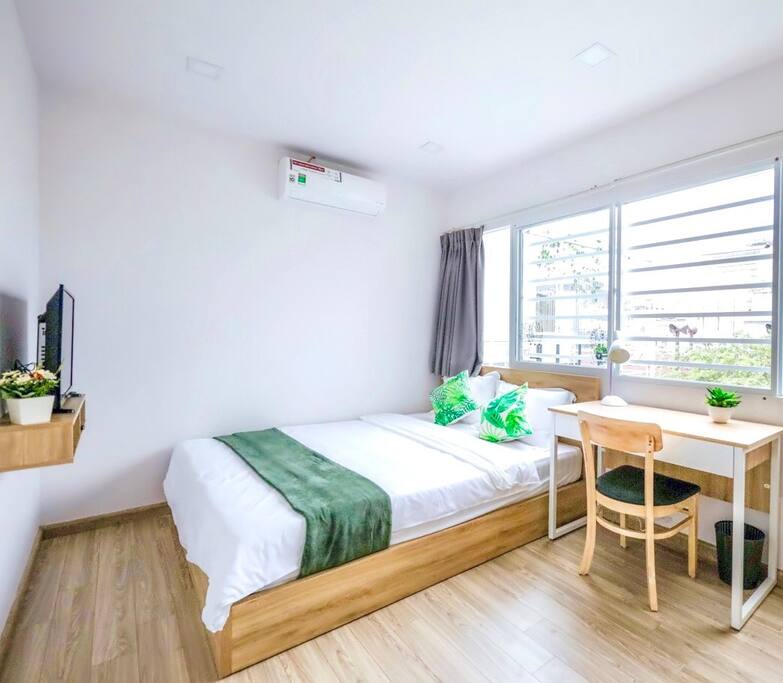 rooftop bedroom with large windows providing city view