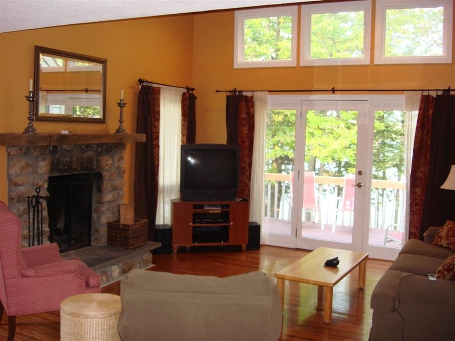 Living room with deck overlooking water.