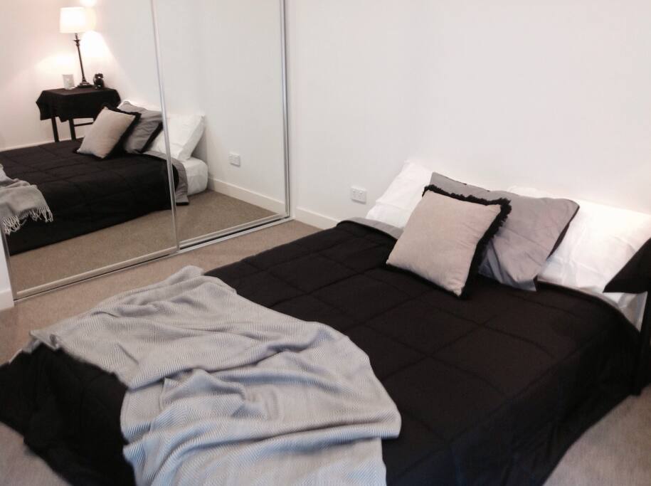Bedroom with mirrored built-ins