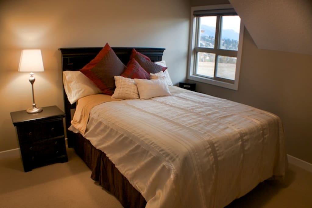 Master Bedroom with walk in closet, ensuite and view directly onto Lake Windermere and the moantains.
