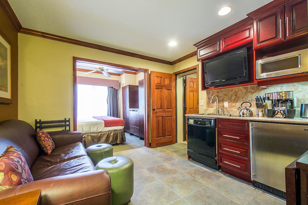 Stocked Kitchenette includes: Oversized Bar Fridge, Microwave, 2-Burner Stove, Dishwasher & Flip-Top Table