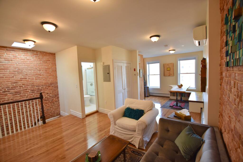 view of entry, bath, and dining area