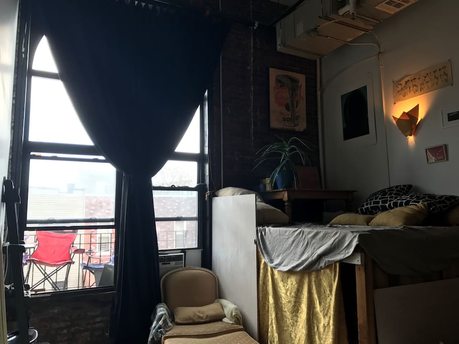 Window to terrace seating and single bedroom.