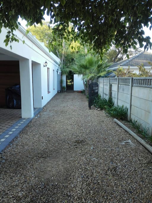 Driveway and parking towards flat. Secure, open parking for one vehicle and a trailer behind security gates next to the flat.