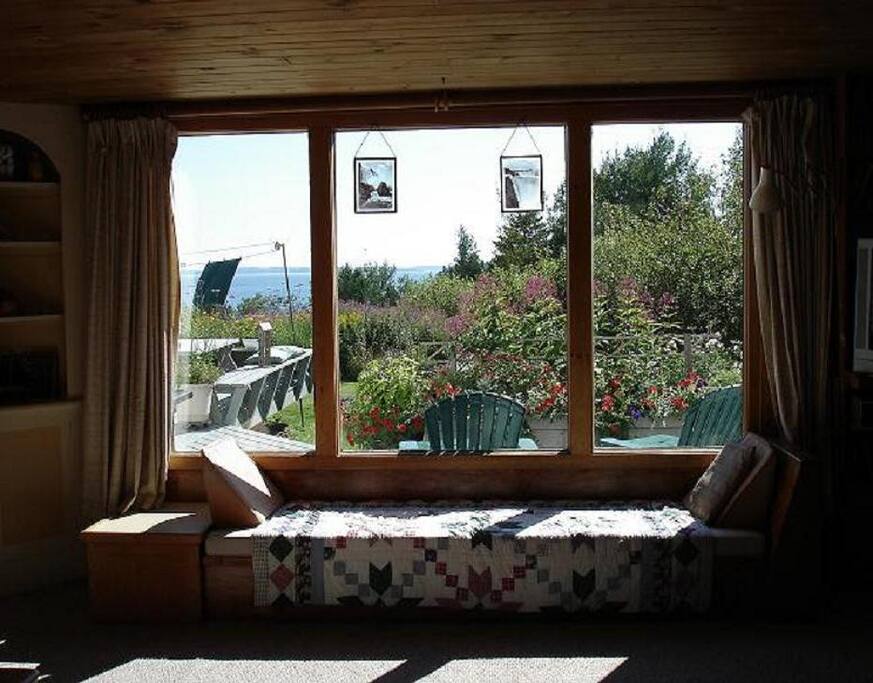 View from living room onto deck & gardens, cove and bay