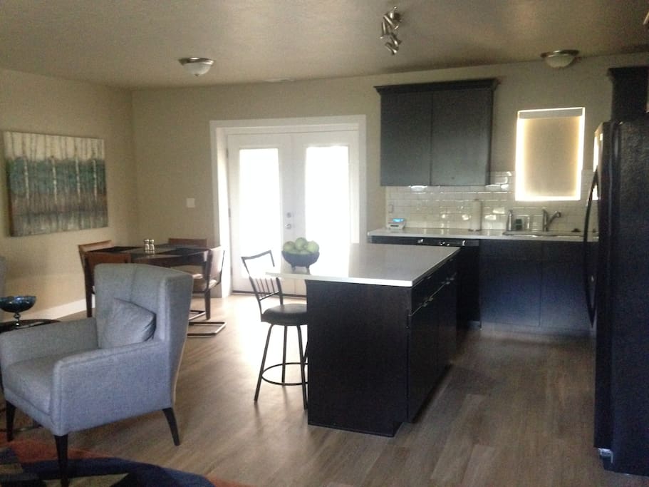 As you walk in the front door. Kitchen straight ahead, living room to your left, and dining area to the left of the kitchen. Nice big open space
