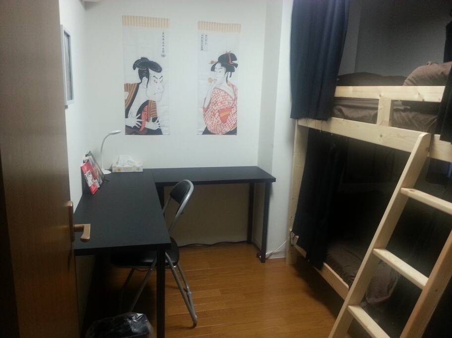 Sturdy bunk bed. Both bunks have 2 pillows, blankets, curtains, lamps, and bed-side tables.
