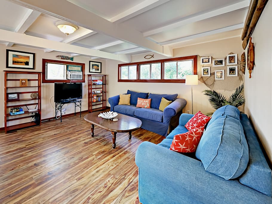 A large sofa and love seat surround the 38” flat screen TV with cable in the living room.