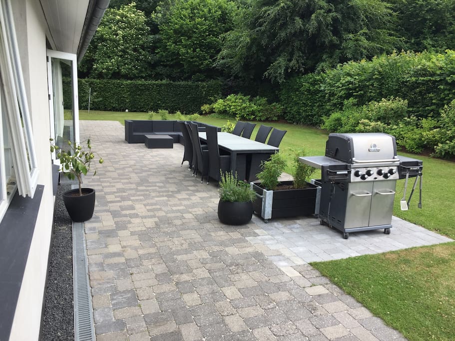 Terrace with lounge sofa, dinning table and gas barbecue