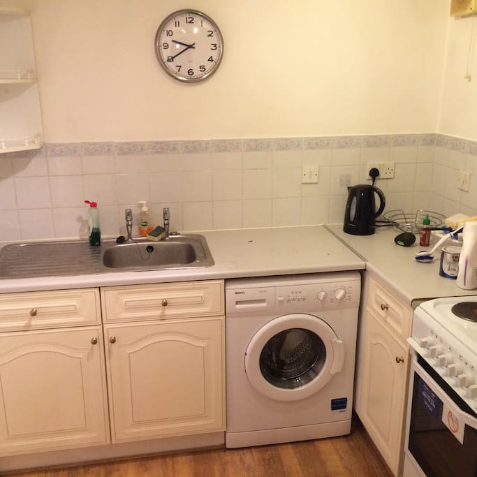 Kitchen with fridge, freezer, cooker and washer.