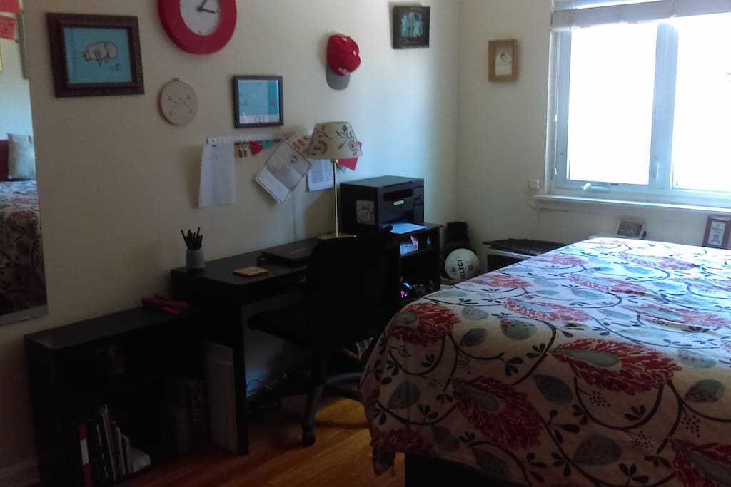 Different angle of bedroom #1. There's a desk for workin' and a printer for printin'.