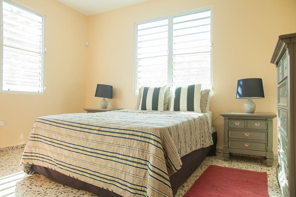 Master bedroom suite flooded with natural light and cool breezes