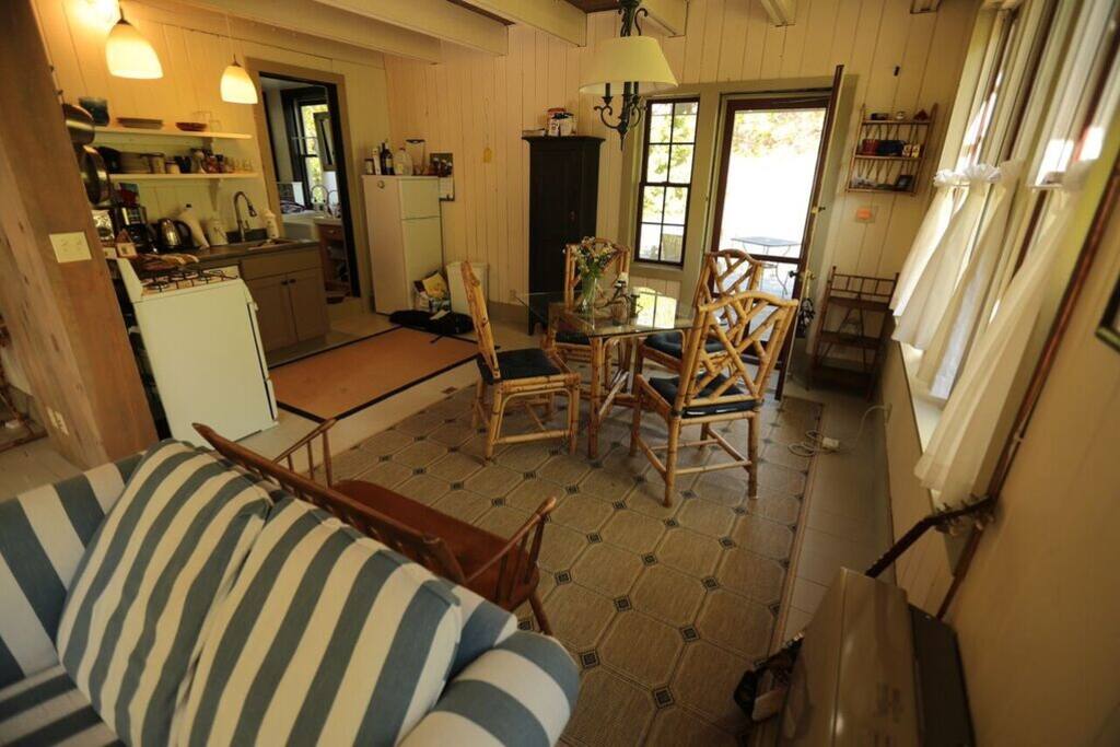 The first floor is flooded with light. The living room flows into the dining area and beyond is the door to the deck