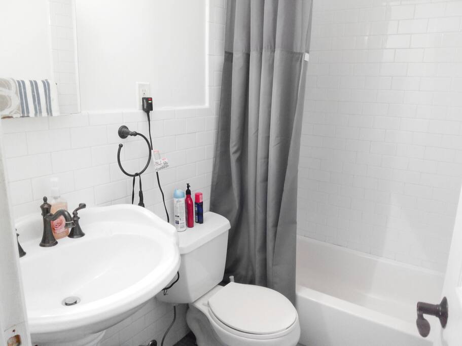 Shared bathroom and toilet--clean and minimal.