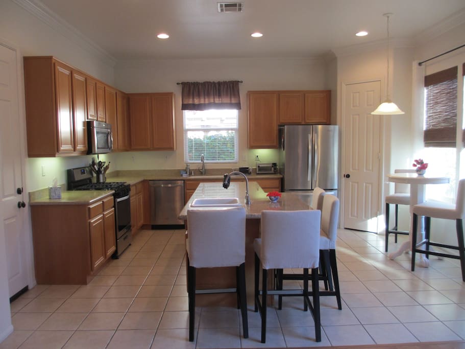 The bright kitchen is fully equipped with comfy seating.