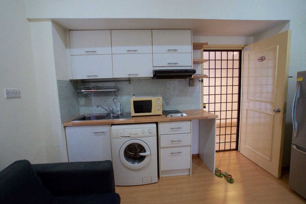 Small kitchen with basic appliances for light cooking.