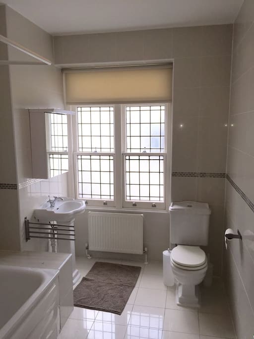 Spacious bathroom with bath and shower