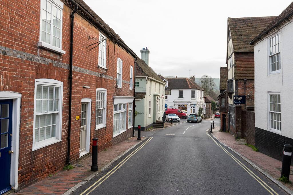 The cottage, looking down High Street. The green building is The Bull. The South Downs (Ditchling Beacon) straight South.