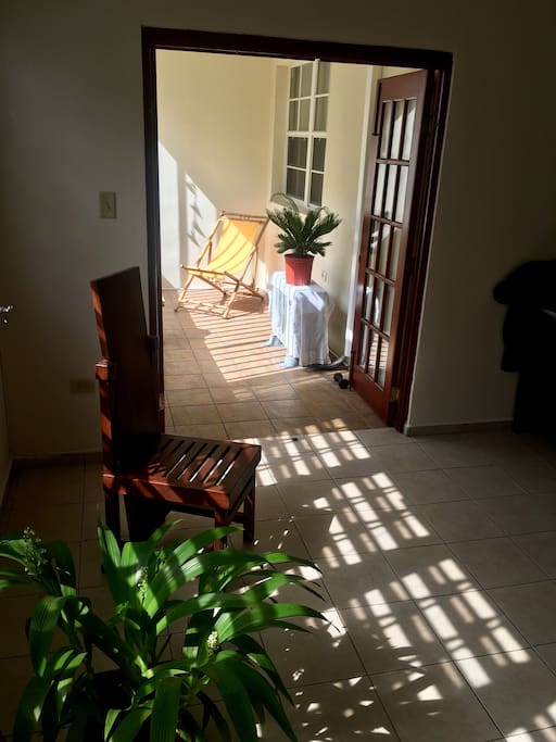 Balcony located next to living area near entrance of the apartment.