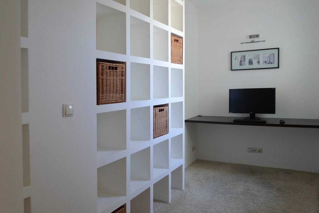 Home office with library. Computer chair is available in the appartment.