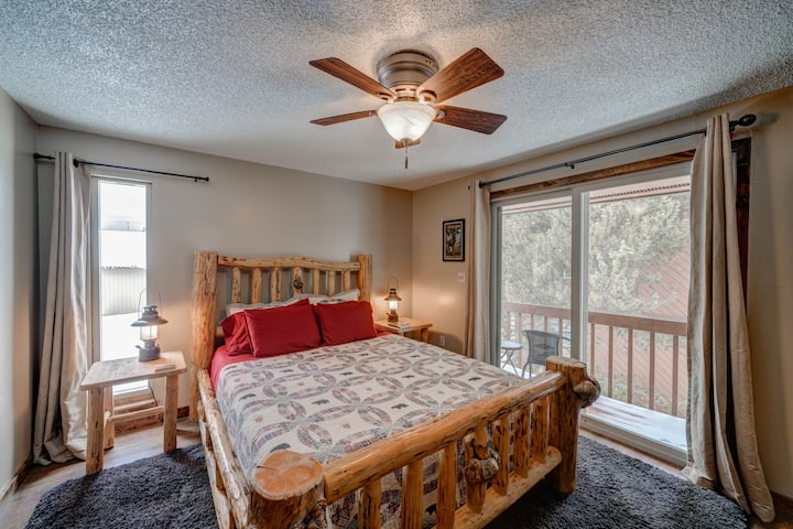 The spacious and comfortable master bedroom features a queen-sized bed and small balcony. "Our rooms looked just like the pictures- clean and cozy." - Jenny