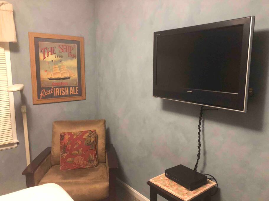 Large wall mounted TV and cozy reading nook