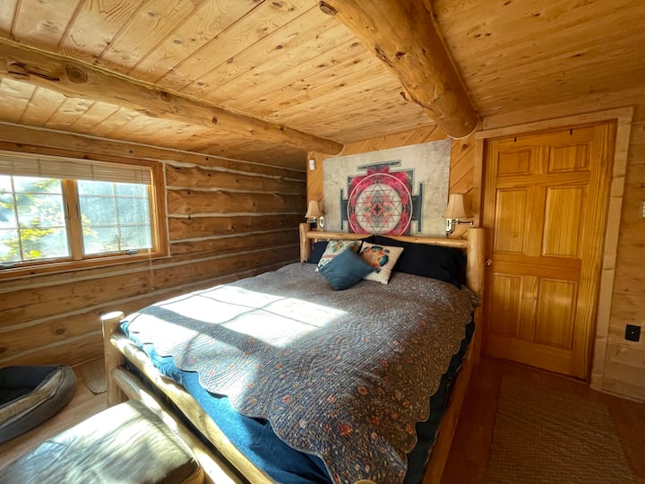 The king bed is outfitted with flannel or bamboo sheets & a down comforter with duvet.  There are two dressers & a small walk-in cedar closet.  Walk out onto the back deck from here or enjoy the view of the river from the bed.
