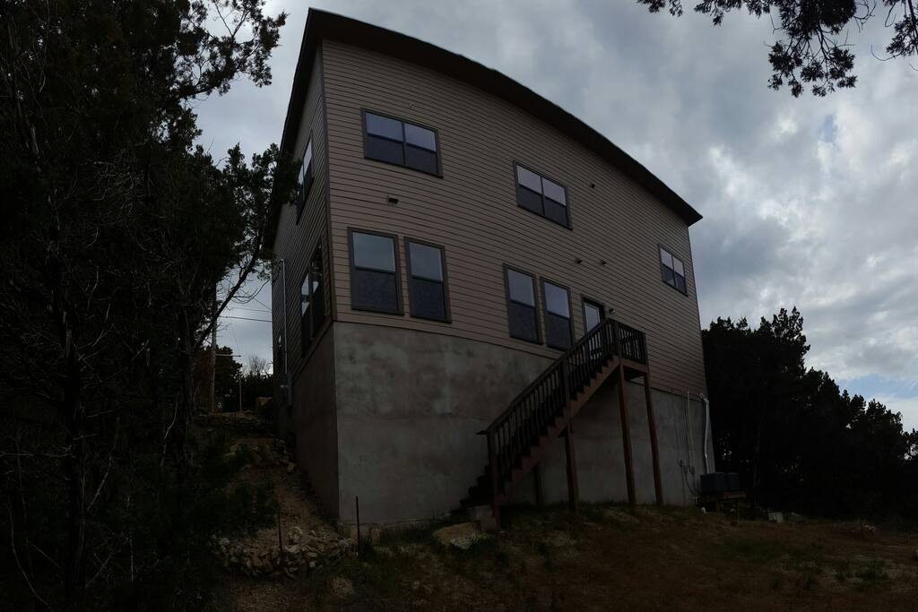 Rear of home, access to greenbelt trails. 40 foot foundation gives you great Austin Hill Country views.