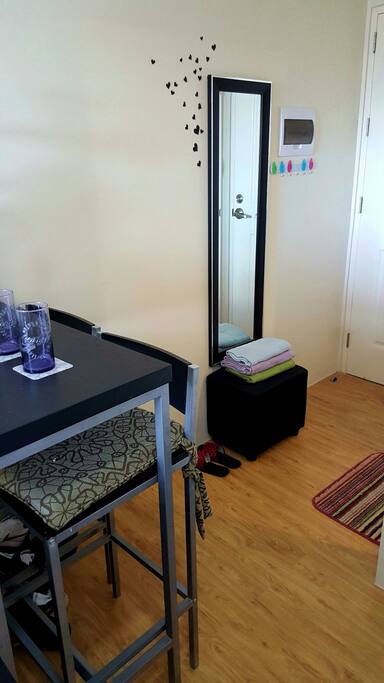 A bar counter with 2 high chairs. Treat your visitors with some refreshments.