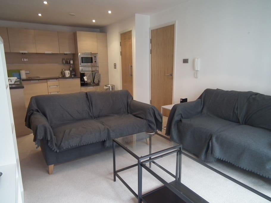 Living room, two double sofas and two coffee tables overlooking 32" TV with Sky TV