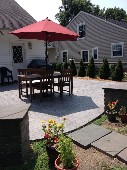 Gas grill and patio adjacent to screened in porch.