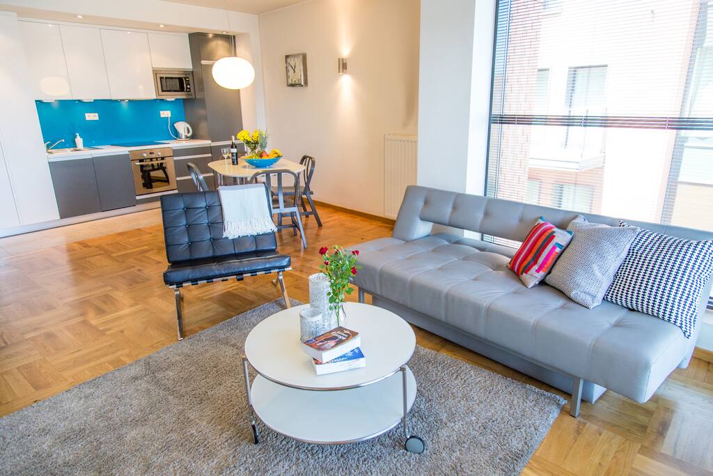 Living room with sofa, TV and balcony