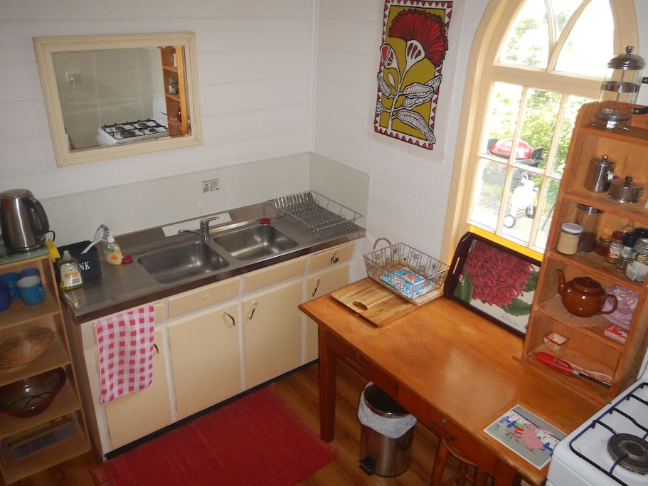 Cute well equiped kitchen with gas stove.