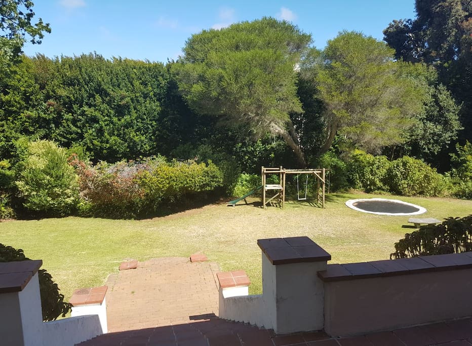 Large back garden from back patio with jungle-gym & trampoline