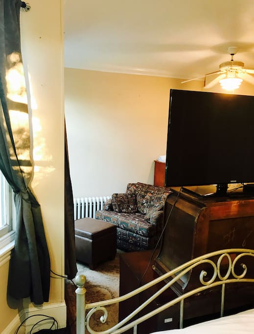 Private room includes TV (direct tv, Netflix, movie channels) and an oversized chair (background) which turns into a bed.