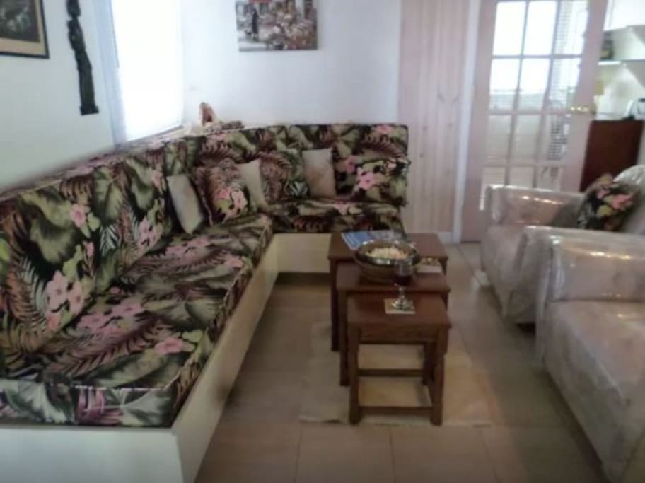 Sitting area between kitchen and downstairs bedroom. Exits to a porch and garden