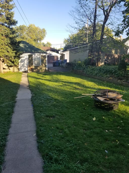 View of backyard with sidewalk to the garage
