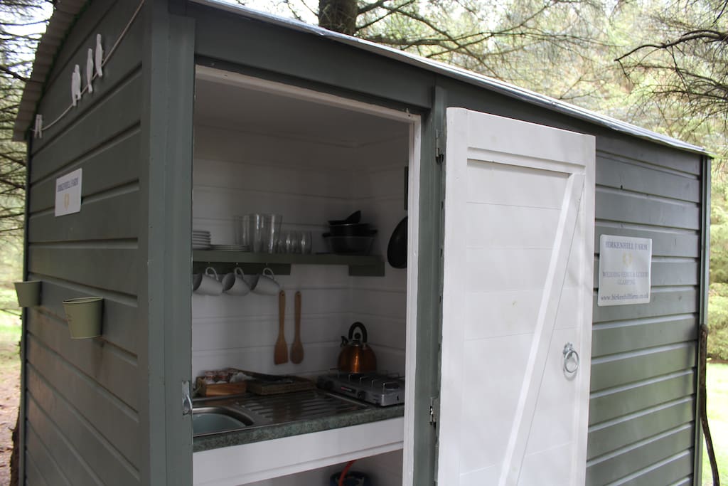 Kitchen, toilets and shower, tucked away in the woods in our shepherds hut.