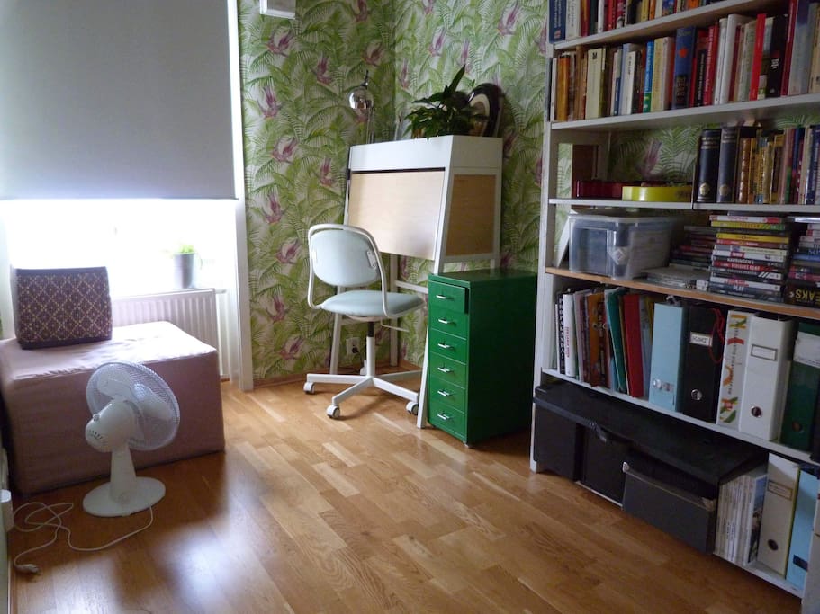 Room with bed folded. Practical desk can be opened and used by guests. Light blocking roll-down curtain.