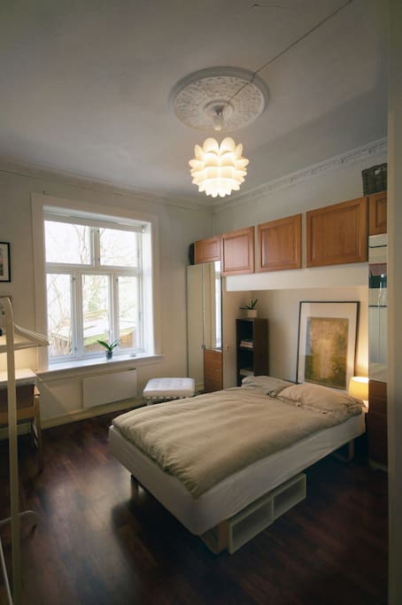 This will be your bedroom: a spacious, calm, cozy room with a queen sized bed.