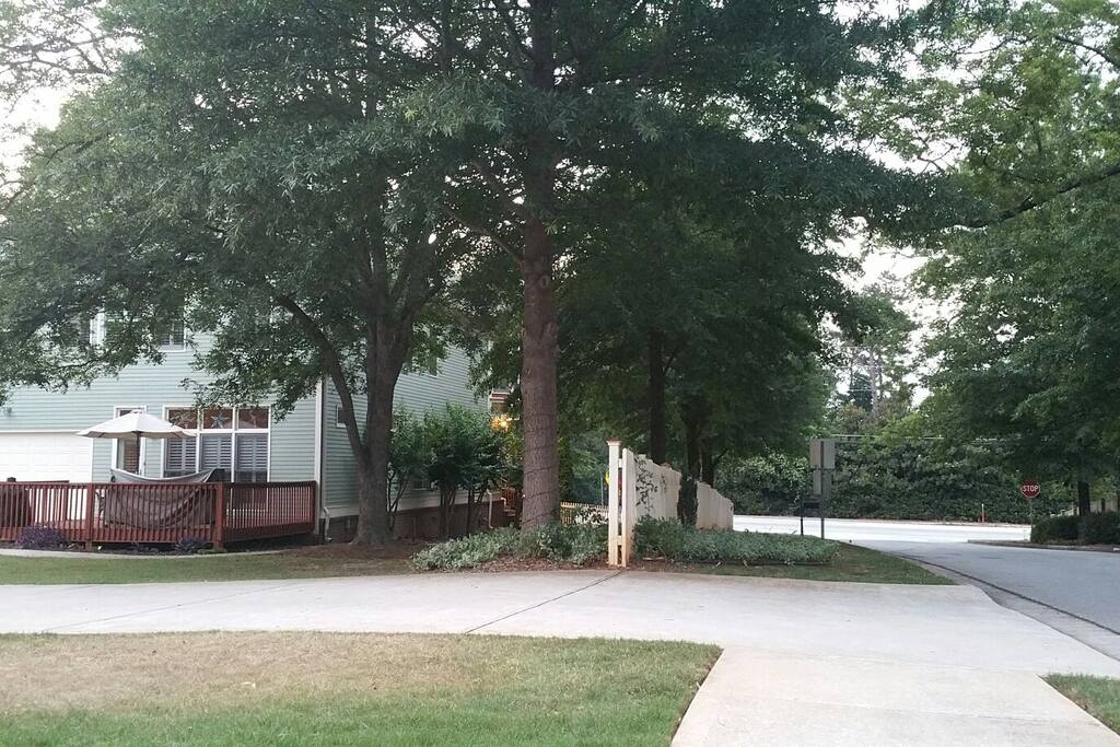 Semi-private, fenced yard with lots of mature shade trees and room for outdoor activities.