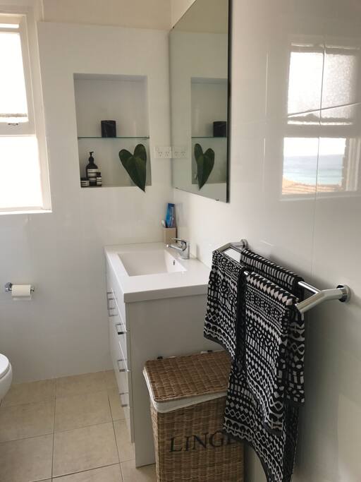 Bathroom with washing machine, shower and ocean views