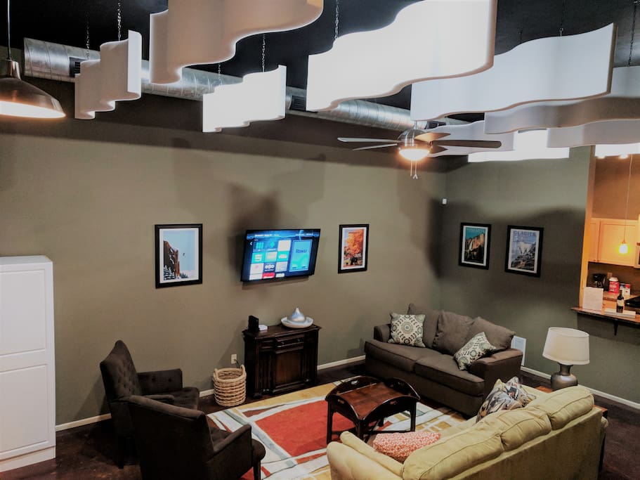 There's room for a crowd in the living room! Modern waves float beneath the ceiling, creating ambiance.