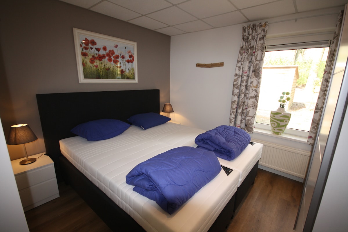 Ruime slaapkamer 1 met twee nieuwe boxspring bedden, ruime kledingkast en nachtkastjes.
En een wastafel met spiegel.